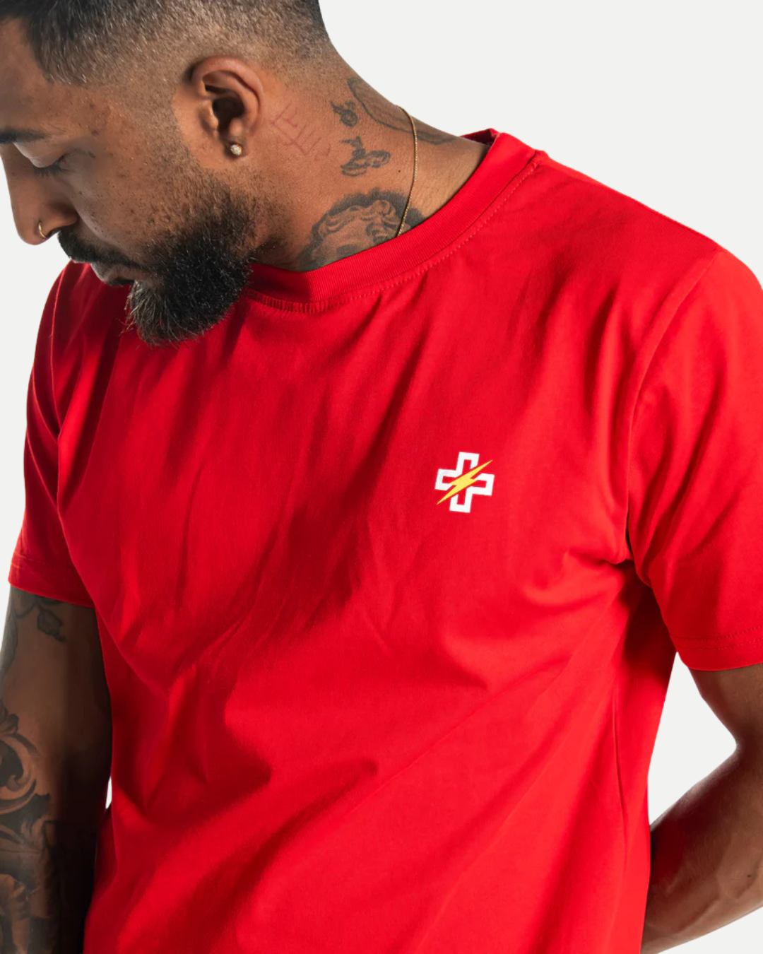 Close-up of PSTVNRG icon on red T-Shirt